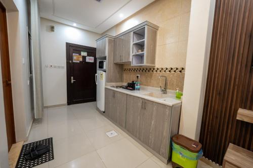 a small kitchen with a sink and a refrigerator at راحتي هنا للشقق المخدومة 7 in Riyadh