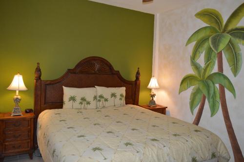 a bedroom with a large bed with a green wall at Palacio del Mar Rocky Point by Castaways in Puerto Peñasco