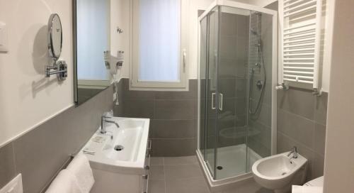 a bathroom with a shower and a sink and a toilet at Hotel Nuova Mestre in Mestre