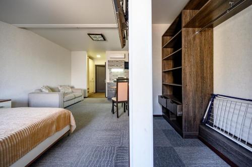 a bedroom with a bed and a living room at Grecheskaya Central Suites in Odesa