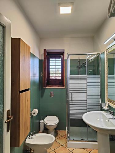 a bathroom with a toilet and a sink and a shower at Case Vacanze Mariposa in Favignana