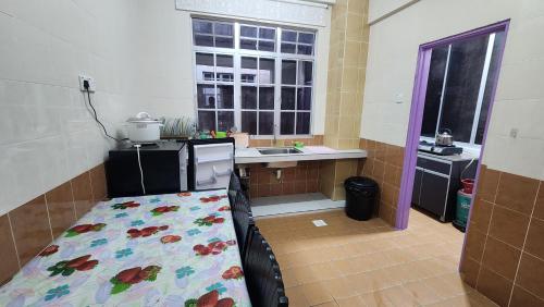 a kitchen with a bed in the middle of a room at Muslim homstay@Crown Imperial Court in Cameron Highlands