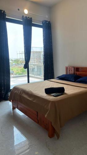 a bedroom with a bed with a large window at Md Couple Stay in Covelong
