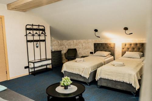 a hotel room with two beds and a table at Naktsmītne - Fišers in Viesīte