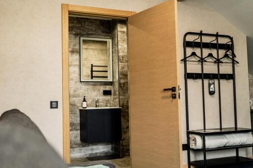 a bathroom with a sink and a mirror at Naktsmītne - Fišers in Viesīte