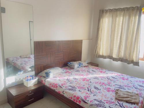 a bedroom with a bed and a large mirror at New Central villa in Bapsai