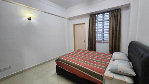 a hotel room with a bed and a window at Muslim homstay@Crown Imperial Court in Cameron Highlands