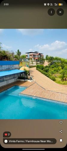 a screenshot of a picture of a swimming pool at New Central villa in Bapsai