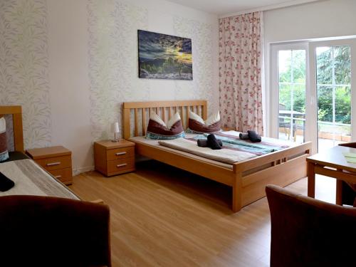 a bedroom with a wooden bed with pillows on it at Ferienwohnanlage Königerode in Königerode
