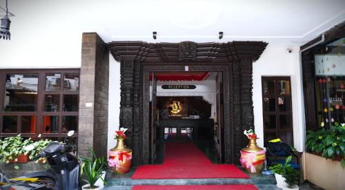 an entrance to a building with a red carpet at Kathmandu Business Hotel in Kathmandu