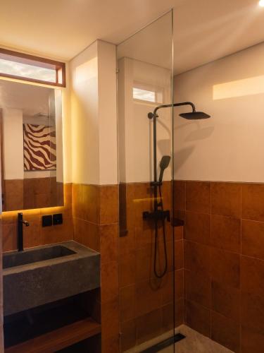 a bathroom with a shower and a sink at Frontera Nyanyi in Tabanan