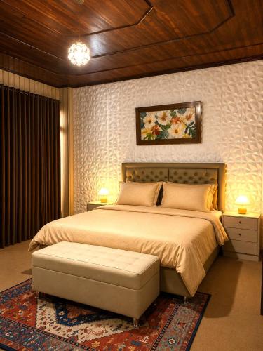 a bedroom with a large bed with a bench in it at Candra Dewi Yogyakarta in Yogyakarta
