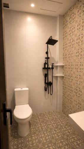 a bathroom with a toilet and a sink at Candra Dewi Yogyakarta in Yogyakarta