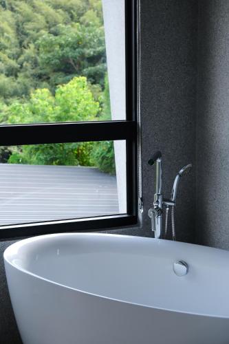 a bathroom with a white sink and a window at Tao Ye BnB in Miaoli