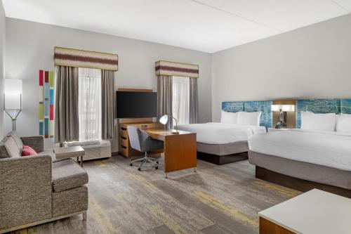 a hotel room with two beds and a desk at Hampton Inn & Suites Augusta West in Quail Creek