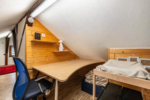 a room with a desk and a bed and a chair at Ferienhaus Mayer in Idar-Oberstein