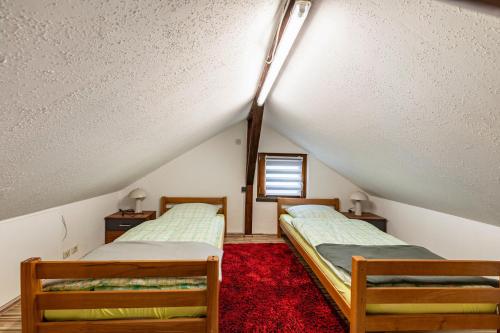 two beds in a room with a attic at Ferienhaus Mayer in Idar-Oberstein