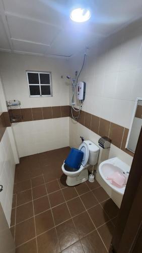 a bathroom with a toilet and a sink at Merlin Home@Crown Imperial Court in Tanah Rata