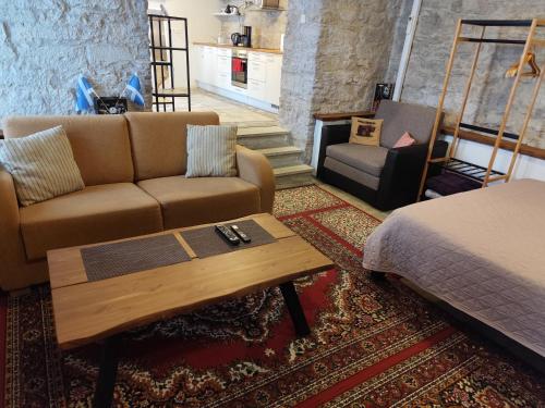 a living room with a couch and a coffee table at Old town Stylish Stonehouse Kauba 6a in Kuressaare