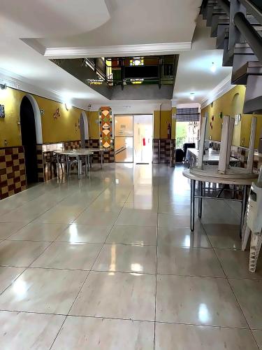 a large room with tables and chairs and yellow walls at Hotel Independência Executive in Goiânia