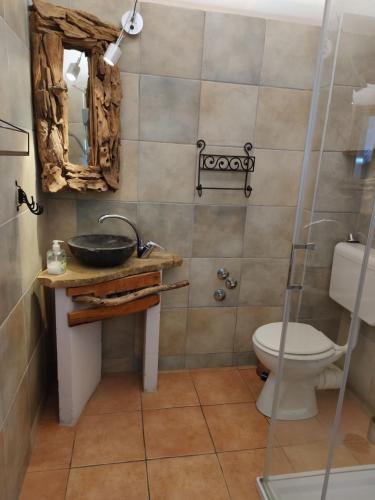 a bathroom with a sink and a toilet and a mirror at Appartement Caspar- Turm Krk in Sveti Vid-Miholjice