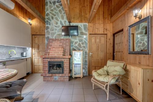 a living room with a brick fireplace in a house at Domki Letniskowe Kobyłocha in Kobyłocha