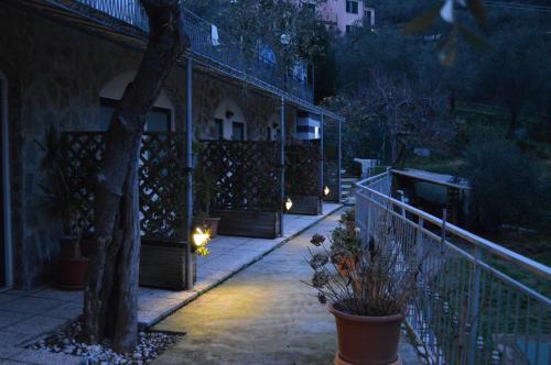 a night view of a house with a fence and plants at Affittacamere arabafenice in Vezzano Ligure