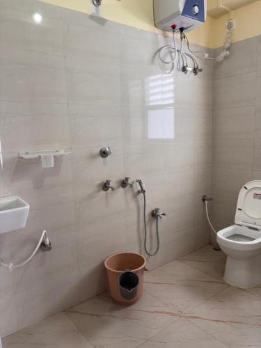 a bathroom with a shower with a toilet and a sink at Spring Valley Homestay Rishop in Rishop
