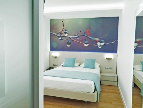a bedroom with a bed with a painting on the wall at Hotel Vila da Guarda in A Guarda