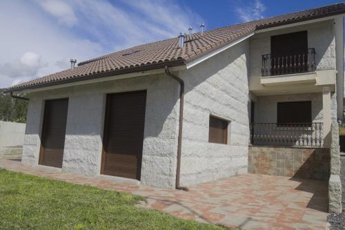 a house with two windows and a balcony at Andreamar in Cambados