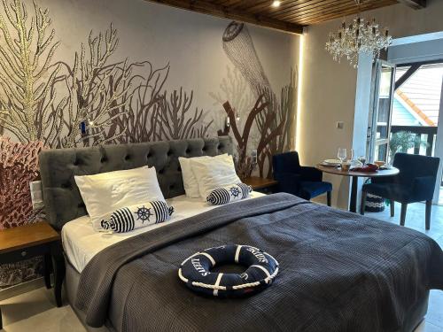 a bedroom with a bed with a hat on it at NOBILTON Dębki in Dębki