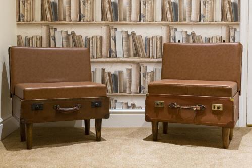 two chairs in front of a book shelf with books at The Resolution Hotel in Whitby