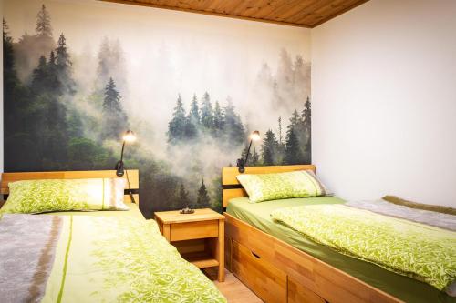 a bedroom with two beds and a painting on the wall at Holzhaus im Schwedenstil in Scharnhorst