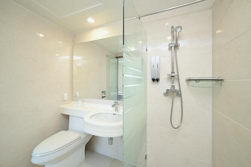 a bathroom with a toilet and a sink and a shower at Staz Hotel Heritage in Jeju