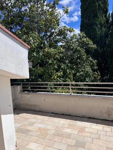 a patio with a fence and trees in the background at Hotel Alex in Florence