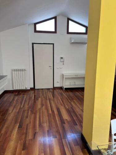 an empty room with a door and a wooden floor at Hotel Alex in Florence