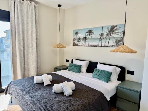 a bedroom with a bed with two towels on it at Azur Mare Luxury Villas in Neoi Epivates