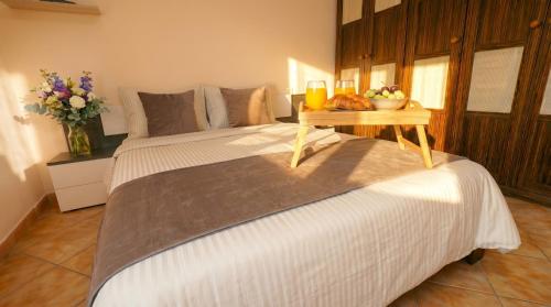 a bedroom with a large bed with a table on it at Apartment Segura 2BD in Rojales