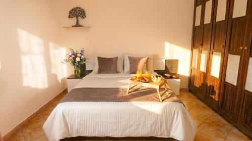 a bedroom with a bed with a tray of fruit on it at Apartment Segura 2BD in Rojales