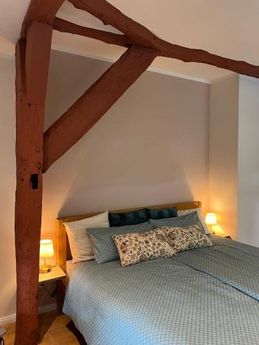 a bedroom with a bed with a wooden canopy at Appartment Casa Verde in Lübberstedt