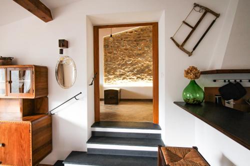 a hallway with a door leading to a bedroom at Come Una Volta Apricale antica dimora ligure - Parcheggio a pochi metri in Apricale