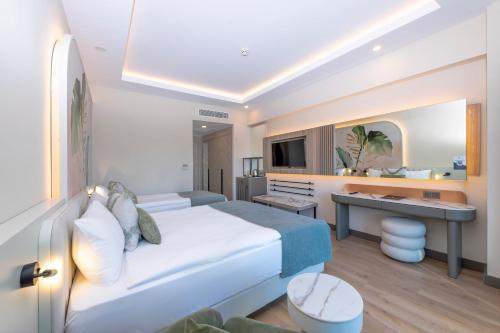 a hotel room with a bed and a desk at Royal Atlantis Icon in Side