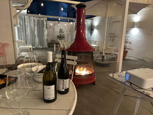 two bottles of wine sitting on a table with a fireplace at Hotel Le'O in Seoul