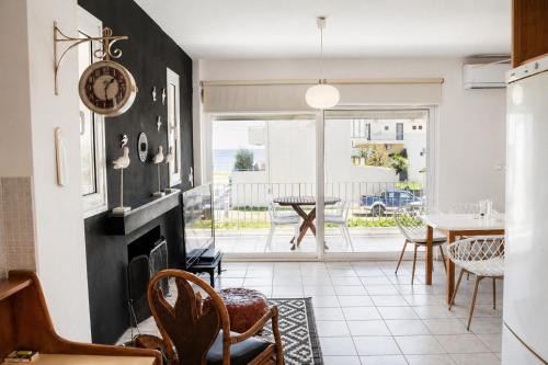 a living room with a fireplace and a table and chairs at Marilia GuestHouse - Seaside Retreat in Evia in Agia Anna