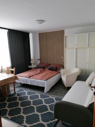 a bedroom with two beds and a couch and a table at Bowal in Grzybowo