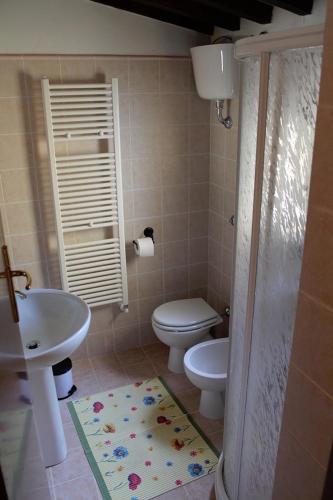 a bathroom with a sink and a toilet and a shower at Casa Vacanze in Borgo in Monteverdi Marittimo