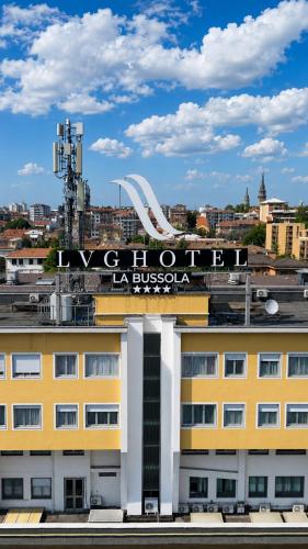a yellow building with a sign on top of it at LVG Hotel Collection - La Bussola in Novara