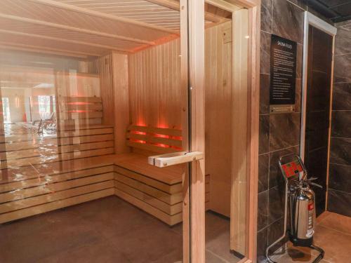 a sauna with a fire inside of a building at Willerby Malton in Ruthin