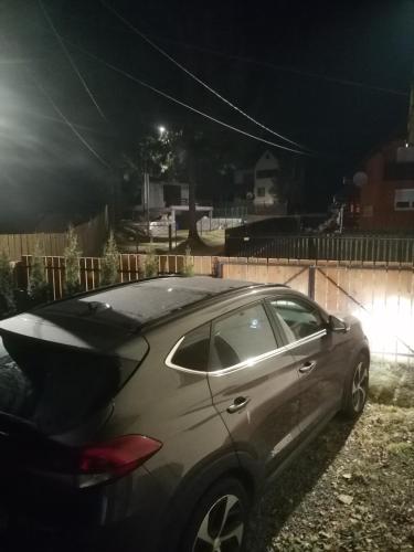 a car parked in a driveway at night at MATT'S House in Tuşnad