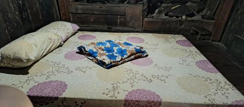 a mattress with a glove on top of it at Ramon's Homestay in Banga-an